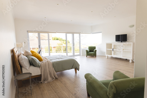 Bright bedroom interior with large windows, at home