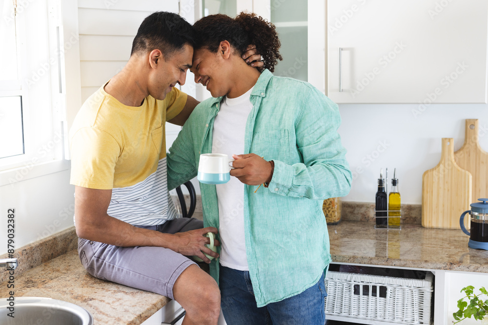 Biracial gay couple enjoys a cozy moment in the kitchen Biracial gay couple enjoys a cozy moment in the kitchen