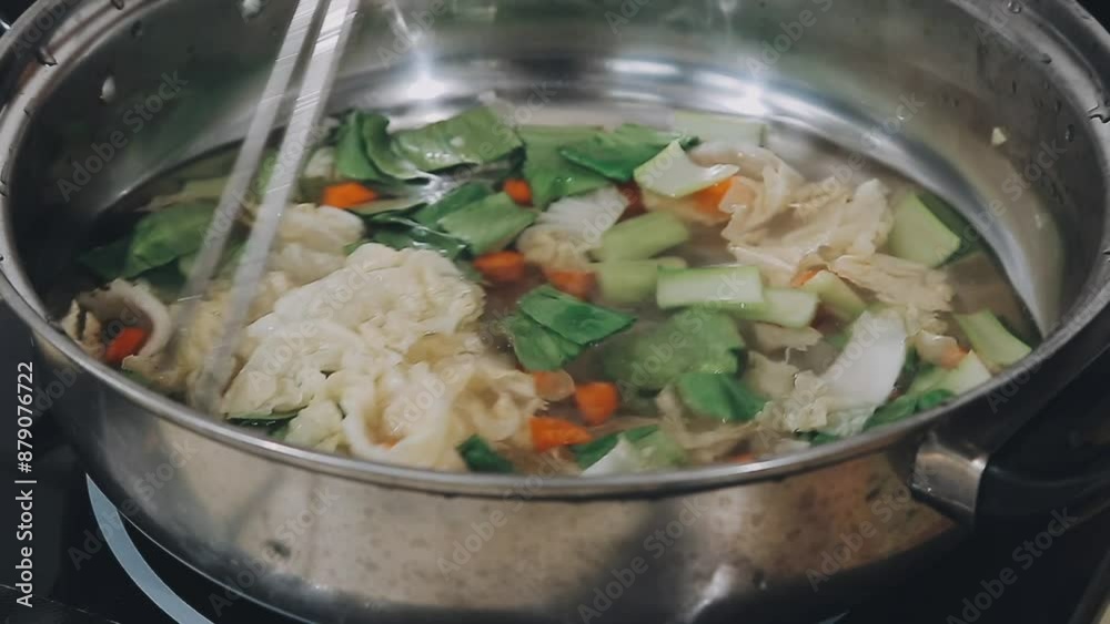 Asian spicy instant noodles soup cooking in hot pot with chopsticks Asian spicy instant noodles soup cooking in hot pot with chopsticks