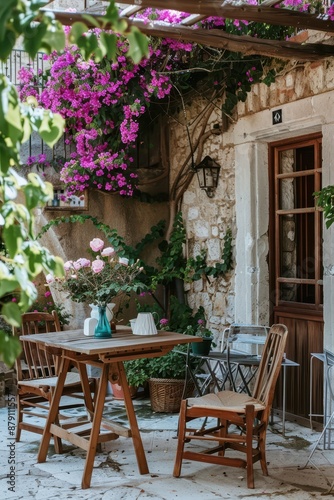 Charming Patio with Pink Bougainvillea and Wooden Furniture © Naturalis
