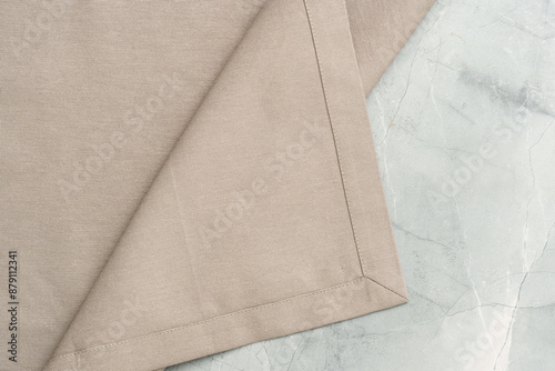 Close Up of a Beige Fabric Napkin Folded on a Marble Surface