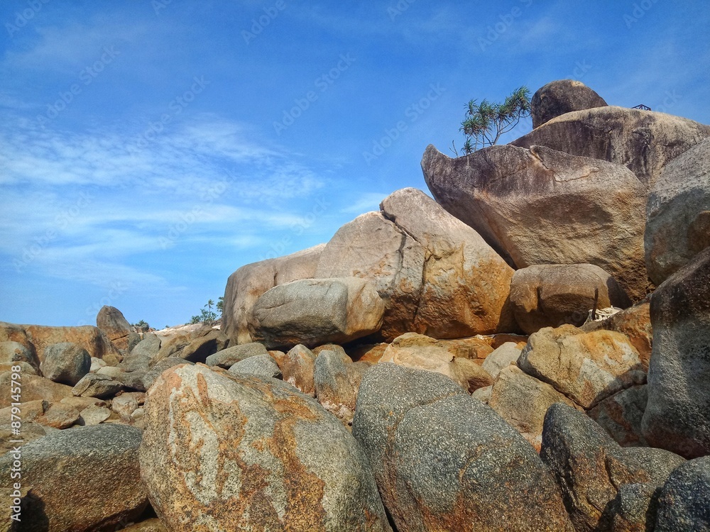 Granite stones and blue sky at the Turun Aban beach, Bangka Island Granite stones and blue sky at the Turun Aban beach, Bangka Island