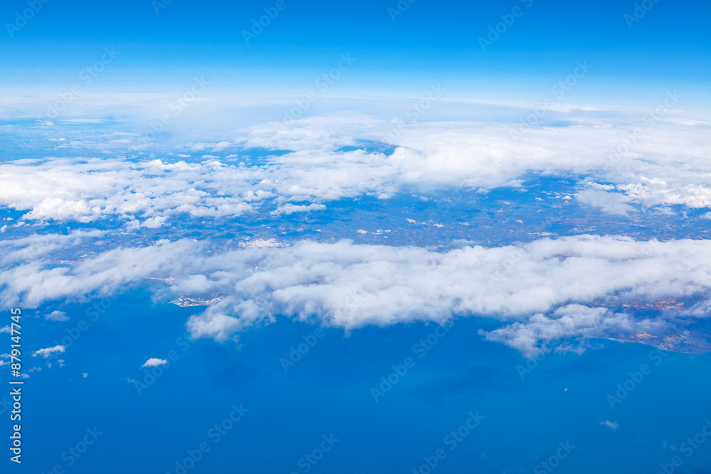 Aerial view of ocean and clouds from airplane window. Earth continent seen from above Aerial view of ocean and clouds from airplane window. Earth continent seen from above