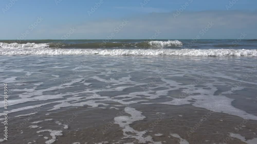 Mediterranean sea in spring. Small waves crash on the beach Mediterranean sea in spring. Small waves crash on the beach