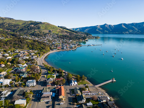 Obraz na płótnie Akaroa, New Zealand: Aerial drone view of the stunning Akaroa idyllic village in the Banks Peninsula in the Christchurch region of Canter bury in New Zealand south island on a sunny day. w salonie