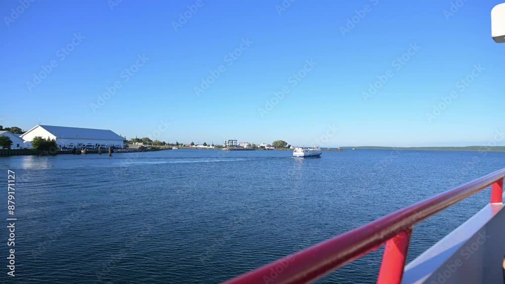 two ferry boats leave St. Ignace, Michigan for arrival at tourism destination Mackinac Island, Michigan state park two ferry boats leave St. Ignace, Michigan for arrival at tourism destination Mackinac Island, Michigan state park