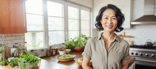 mature asian woman smile in kitchen at home