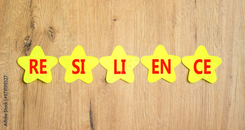 Wallpaper Mural Resilience symbol. Concept word Resilience on beautiful yellow paper stars. Beautiful wooden background. Business resilience concept. Copy space. Torontodigital.ca