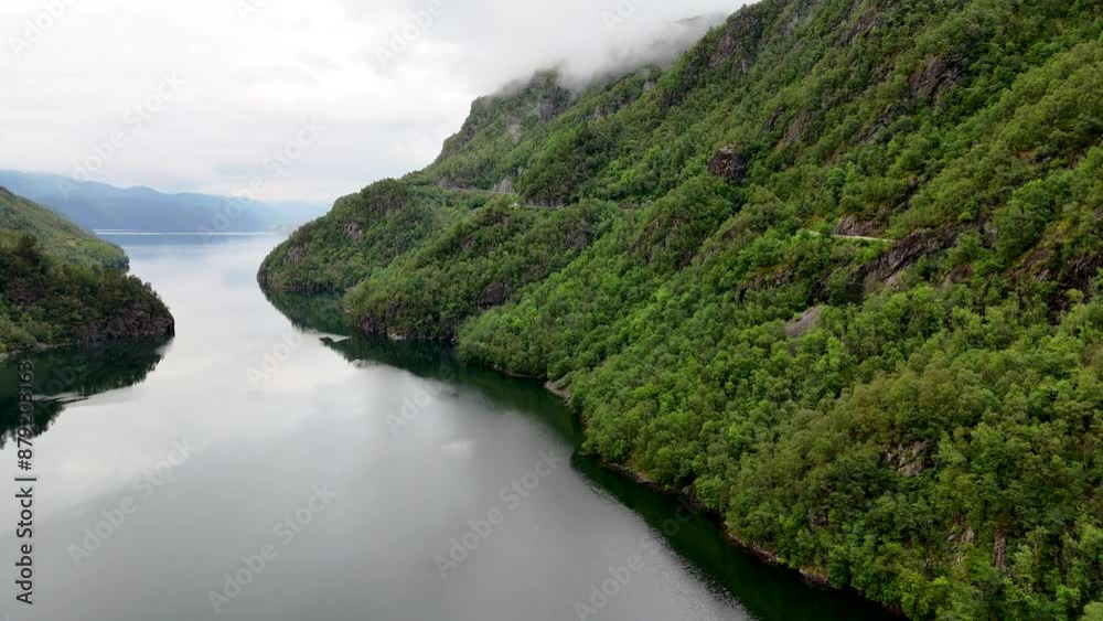 A stunning aerial video of a tranquil river, lake, mountains, and trees captures the serene beauty of nature in exquisite detail, offering a peaceful viewing experience, Lovrafjorden, Norway A stunning aerial video of a tranquil river, lake, mountains, and trees captures the serene beauty of nature in exquisite detail, offering a peaceful viewing experience, Lovrafjorden, Norway