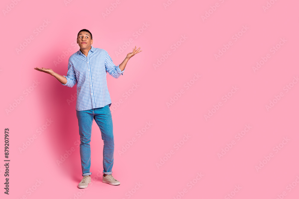 Full length photo of doubtful uncertain guy dressed checkered shirt shrugging shoulders emtpy space isolated pink color background Full length photo of doubtful uncertain guy dressed checkered shirt shrugging shoulders emtpy space isolated pink color background