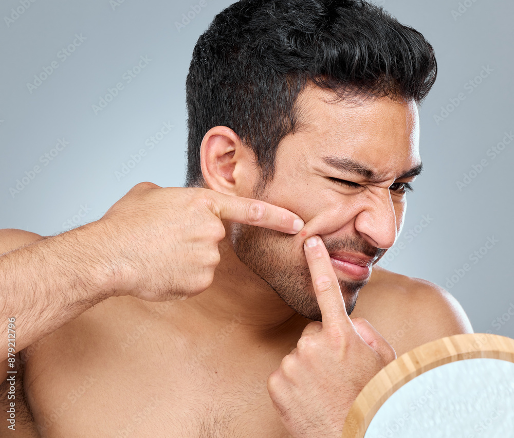 Obraz premium Squeeze, fingers and pimple for man, skincare or mirror for cosmetic on white background. Dermatology, studio or beauty for cosmetic acne for male person, blackhead or selfcare for grooming treatment