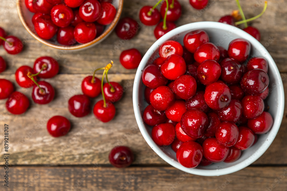Cherries. Fresh ripe cherries with leaves on a textured wooden background. Fresh sweet organic cherry pile. Berries and fruits. Vegan. Healthy eating. Place for text. Copy space Cherries. Fresh ripe cherries with leaves on a textured wooden background. Fresh sweet organic cherry pile. Berries and fruits. Vegan. Healthy eating. Place for text. Copy space
