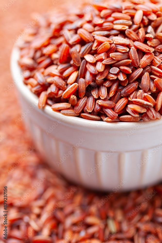 Uncooked, red rice in bowl. Gluten free nutrition Uncooked, red rice in bowl. Gluten free nutrition