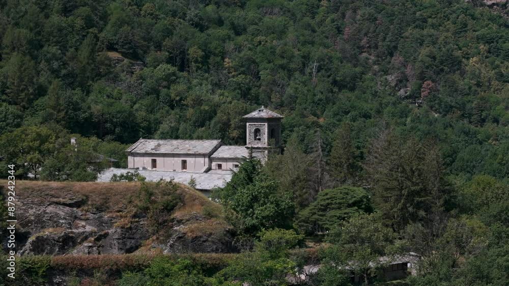 Aerial view of the historic Novalesa Abbey, a Benedictine monastery nestled in the lush landscape of Piedmont, Turin, Italy. Aerial view of the historic Novalesa Abbey, a Benedictine monastery nestled in the lush landscape of Piedmont, Turin, Italy.