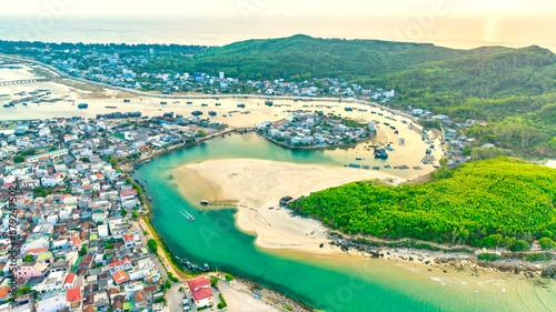 Aerial view of Sa Huynh Bay, including fishing village, transportation system, urban area, the most beautiful beach in Central Vietnam