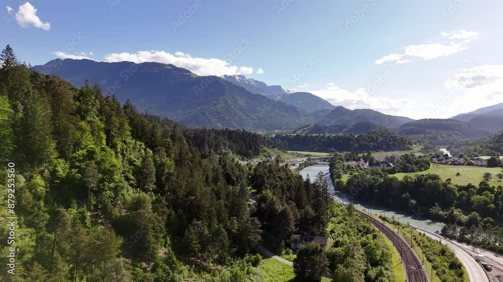 Scenic aerial view of Domat Ems, Switzerland with lush greenery and winding railway tracks Scenic aerial view of Domat Ems, Switzerland with lush greenery and winding railway tracks