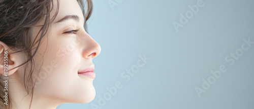 Dramatic lighting with elegant female model showcasing her profile in a studio setting.