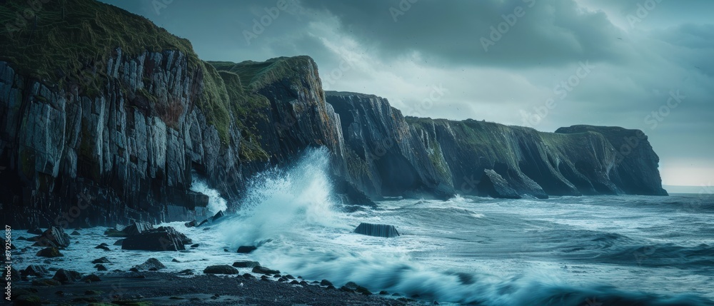 The ocean is rough and the waves are crashing against the rocks
