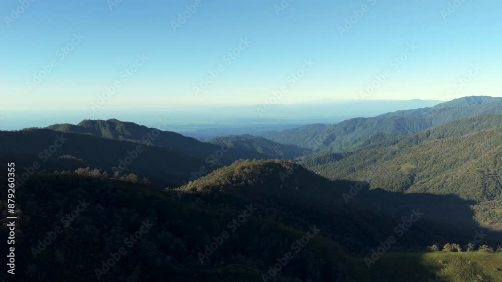 Aerial view Yungas Forest, lush mountain range with light blue sky and sunlight. Aerial view Yungas Forest, lush mountain range with light blue sky and sunlight.