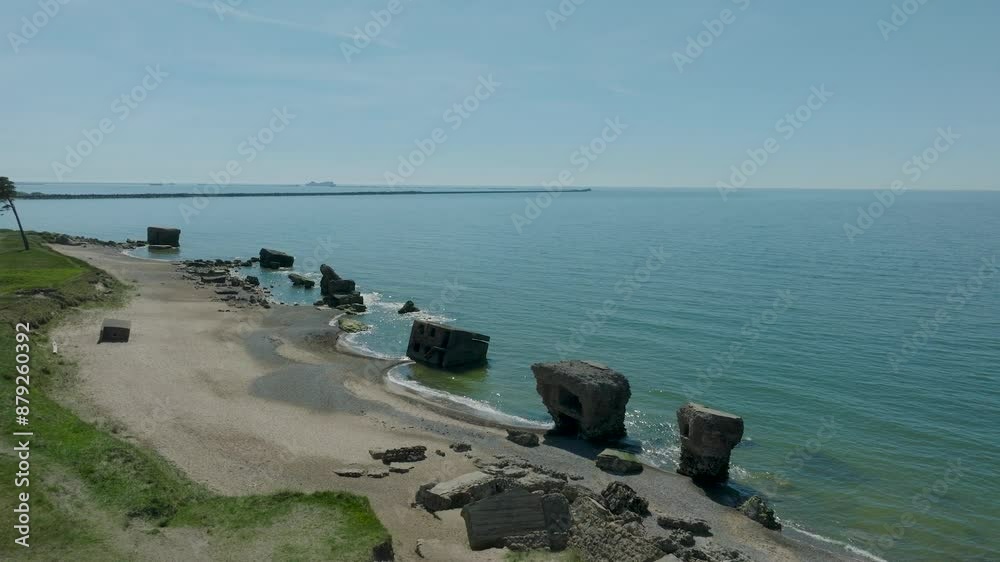 Beautiful aerial establishing view of Karosta (Liepaja) concrete coast fortification ruins, calm Baltic sea, sunny summer day, wide drone shot moving forward Beautiful aerial establishing view of Karosta (Liepaja) concrete coast fortification ruins, calm Baltic sea, sunny summer day, wide drone shot moving forward