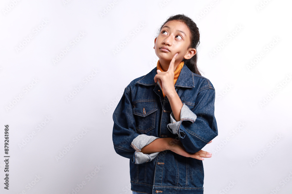 Casual style little girl with thinking expression looking up, imagining isolated on white background Casual style little girl with thinking expression looking up, imagining isolated on white background