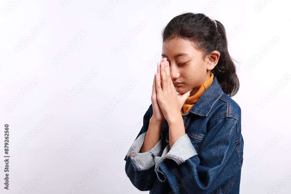 Asian little girl praying to God with hands together. Isolated on white background Asian little girl praying to God with hands together. Isolated on white background