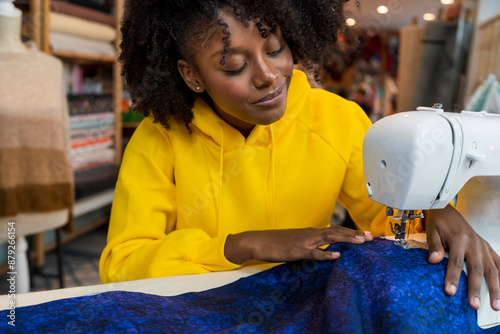 African american girl in her sewing workshop.