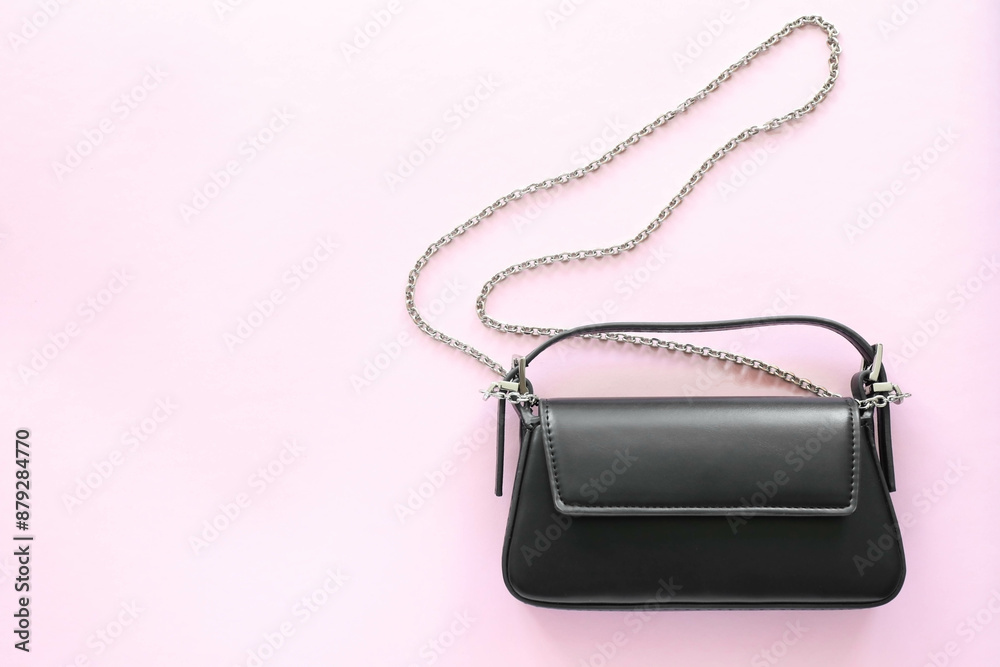 Fototapeta premium Black leather handbag with chain