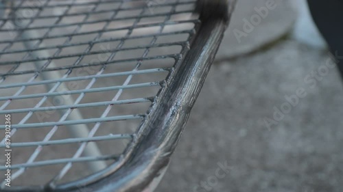 Closeup of brush. Man with protective gloves painting a metal object with gray color varnish
