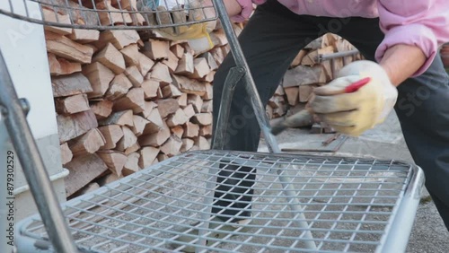 Man painting a chair. Adult worker using a brush to varnishing an object, he's wearing protective gloves
