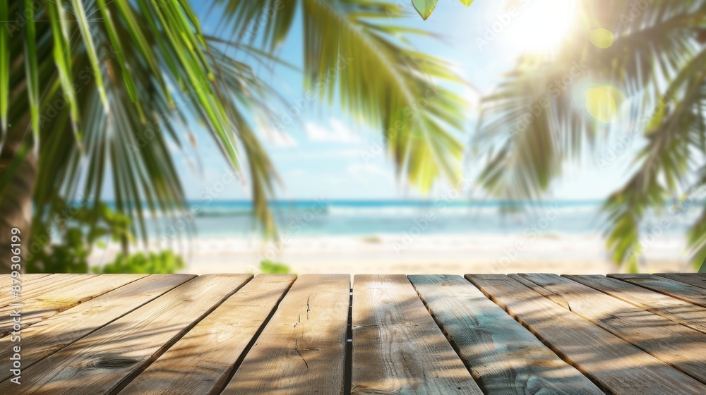 Podium for product presentation. Empty wooden table and palm leaves with blur beach on background in summer time, can be used for product placement Podium for product presentation. Empty wooden table and palm leaves with blur beach on background in summer time, can be used for product placement