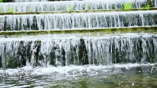 Slow motion of water running down the stone step