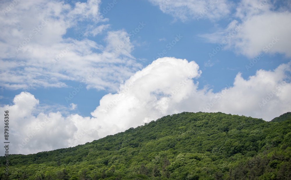 Nature, forested mountains, blue sky with white clouds. Nature, forested mountains, blue sky with white clouds.