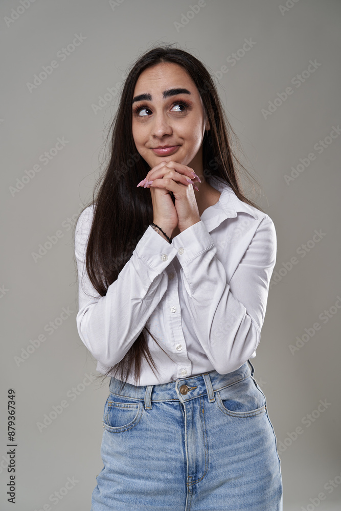 Hispanic businesswoman praying to get a salary raise