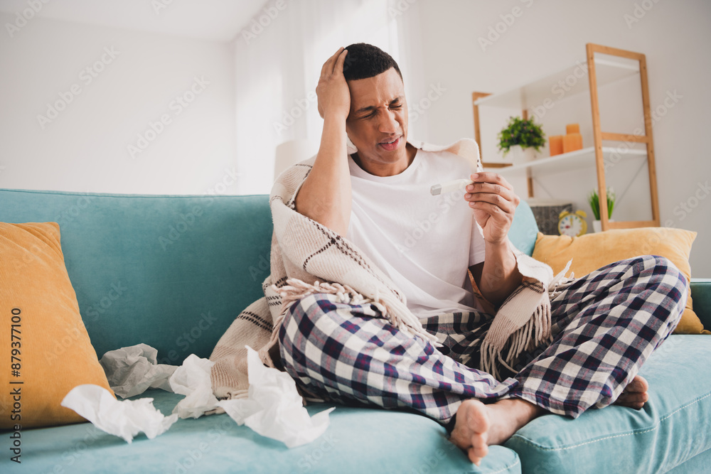 Photo of unhappy upset guy sleepwear pajama measuring temperature feeling bad indoors house apartment room Photo of unhappy upset guy sleepwear pajama measuring temperature feeling bad indoors house apartment room
