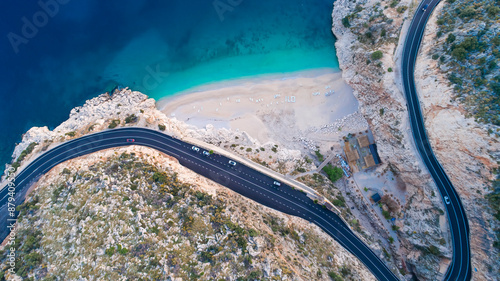 Fototapeta Naklejka Na Ścianę i Meble -  Aerial view of Kaputaş beach from drone. A beautifully winding road along the Mediterranean coast. A wonderful beach with white sand and blue water.