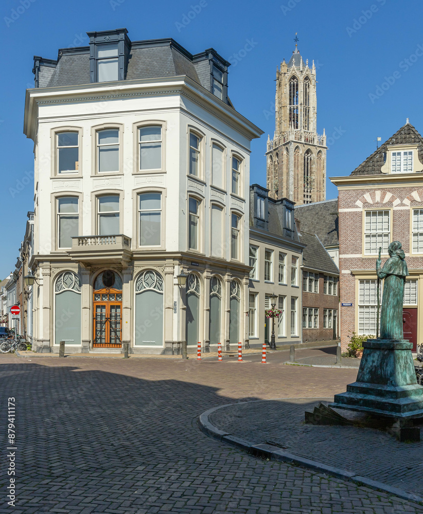 Fototapeta premium Pausdam Utrecht with statue of Adrian VI surrounded by historic buildings and the cathedral Dom tower in the background
