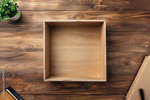 Minimalistic Open Wooden Box on Rustic Table with Plant and Books photo