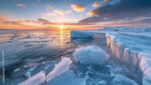 Frozen landscape with icebergs at sunset photo