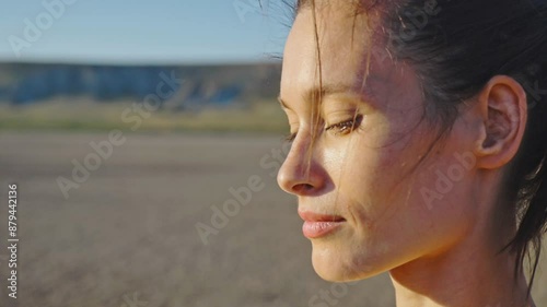 Slow motion. Gorgeous young woman with a charming smile against the backdrop of a gentle magnificent summer sunset. Portrait