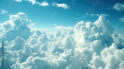 A view from inside an airplane looking out at fluffy white clouds against a blue sky