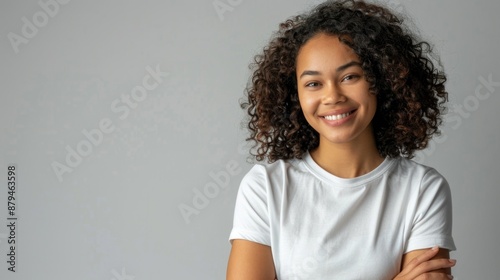 beautiful young smiling woman with curly hair wearing a white t-shirt