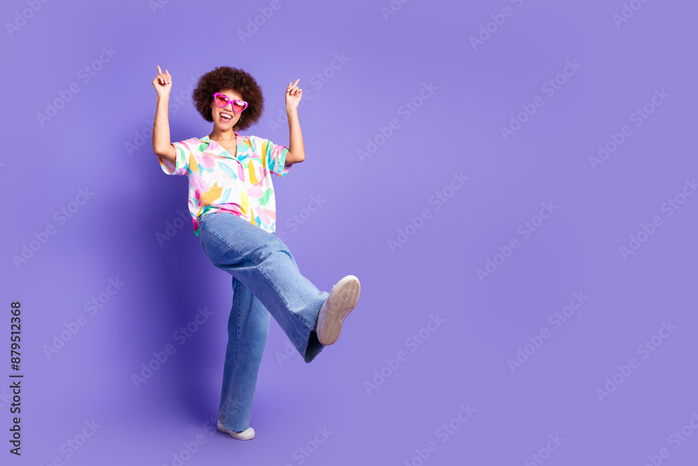 Full size photo of pretty young woman dance point fingers wear shirt isolated on violet color background Full size photo of pretty young woman dance point fingers wear shirt isolated on violet color background