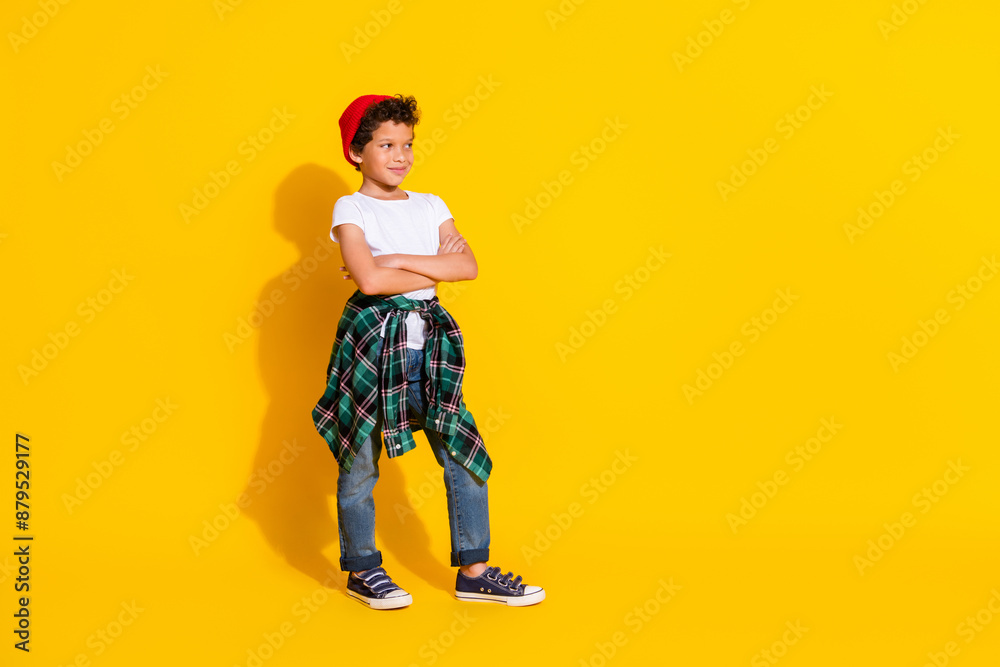 Fototapeta premium Full size photo of small charming boy crossed hands confident wear trendy white outfit isolated on yellow color background