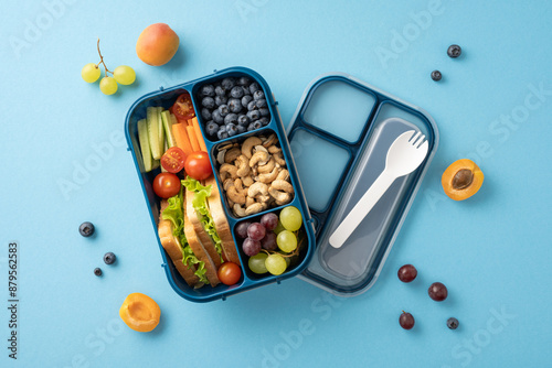 Fotografia Top view of a colorful and balanced school lunch with fresh fruits, vegetables,