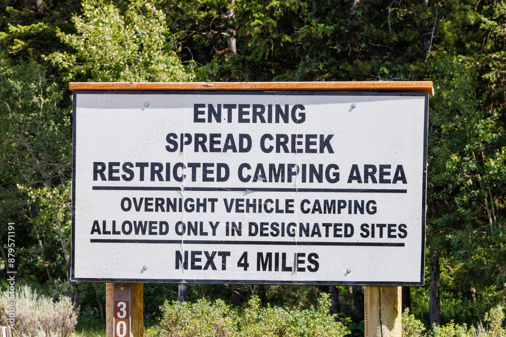 Spread Creek dispersed camping sign in Bridger-Teton National Forest, Jackson Hole, Wyoming during summer. Spread Creek dispersed camping sign in Bridger-Teton National Forest, Jackson Hole, Wyoming during summer.