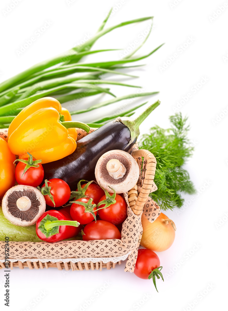 Fresh organic vegetables in the basket. Pepper, eggplant, tomatoes, mushrooms and greenery herbs with green leaves. Healthy natural food. Veggies, isolated on white background Fresh organic vegetables in the basket. Pepper, eggplant, tomatoes, mushrooms and greenery herbs with green leaves. Healthy natural food. Veggies, isolated on white background