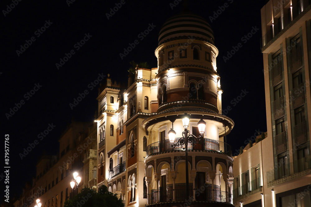 Vintage historical house in downtown in night time in Seville, Spain