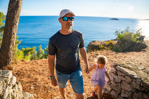 Father and daughter in shore in the bay of Uvala Gradina near the town of Vela Luka on the island of Korcula in Croatia photo