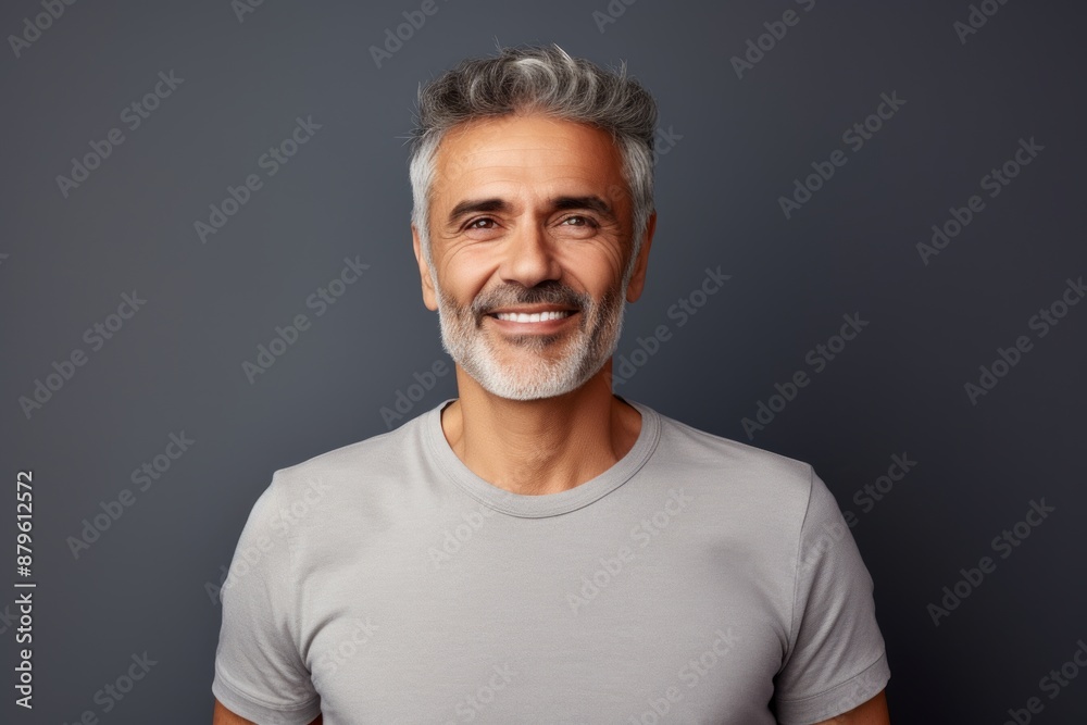 Portrait of a joyful man in his 50s donning a classy polo shirt on minimalist or empty room background Portrait of a joyful man in his 50s donning a classy polo shirt on minimalist or empty room background